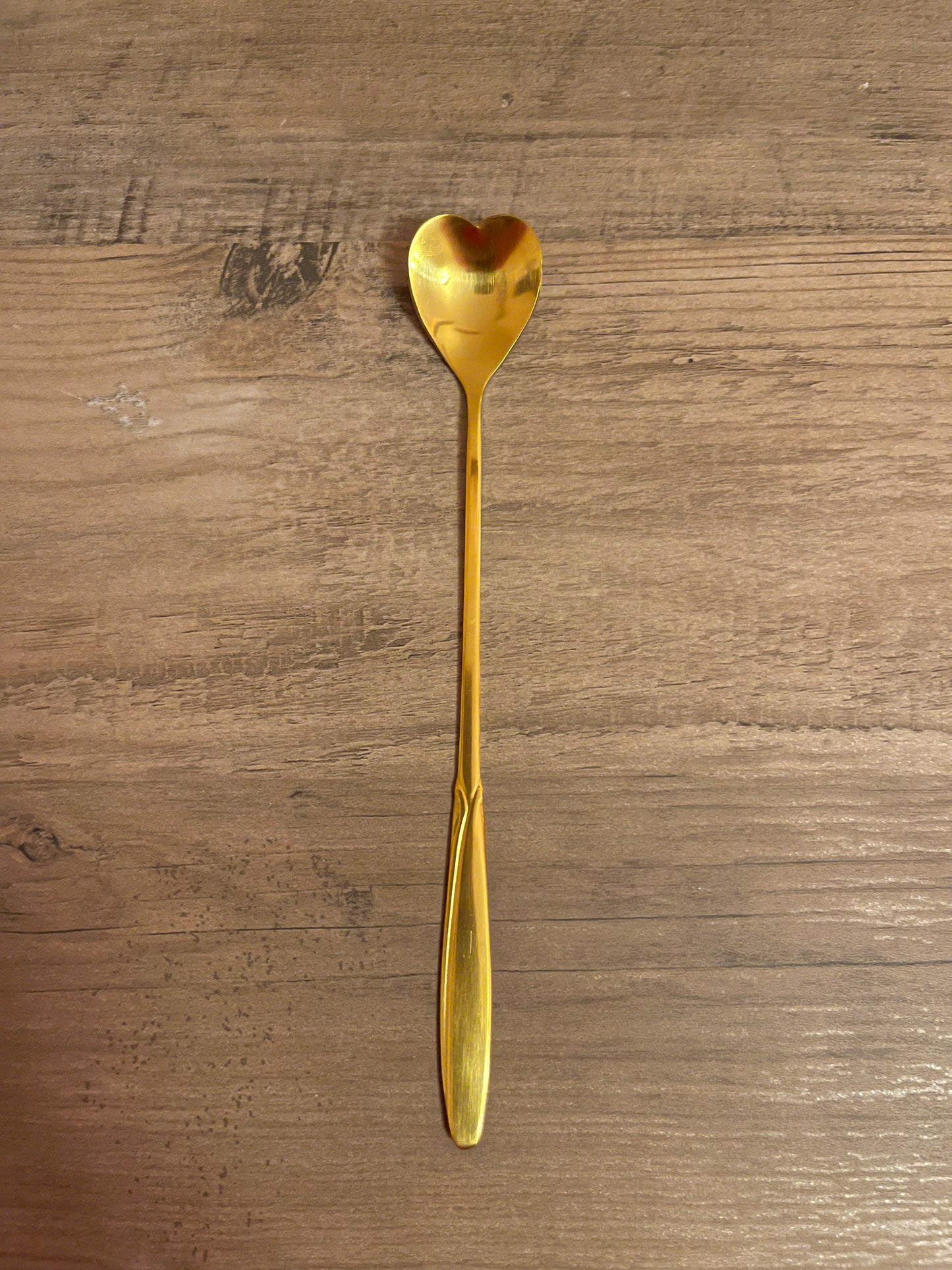 Gold heart-shaped teaspoon.