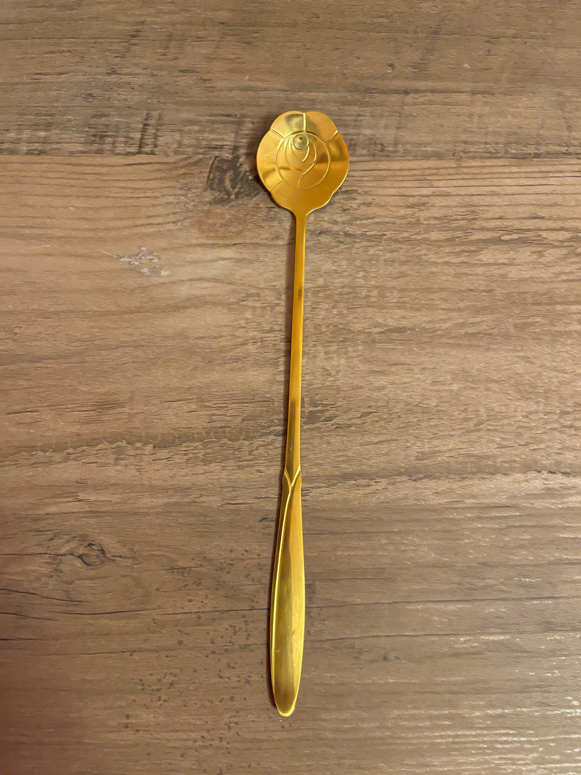 Gold rose-shaped teaspoon.