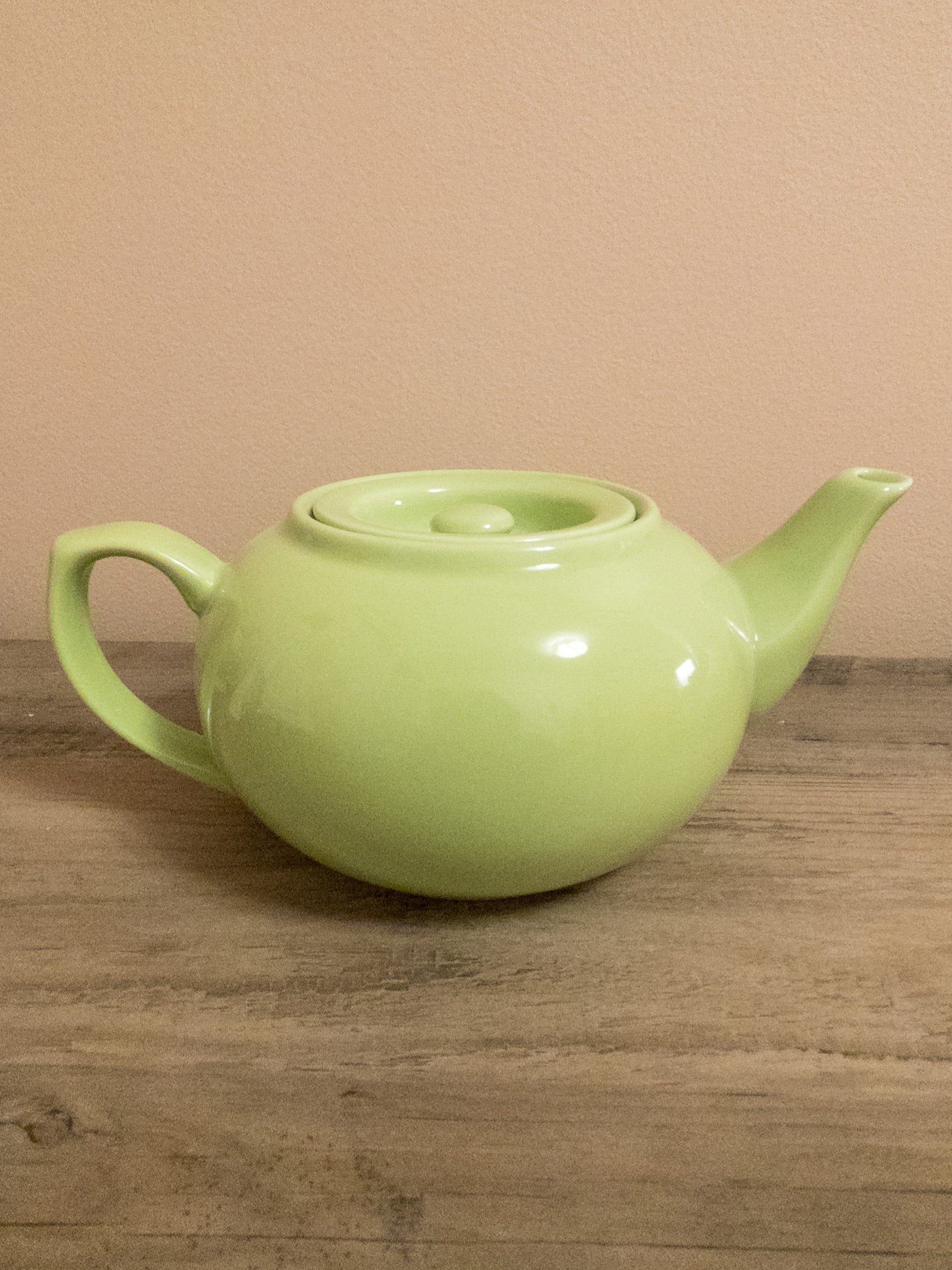 Green ceramic teapot.