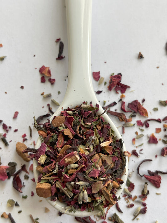 A floral green tea blend with rosebuds and petals, hibiscus, lavender, lemon balm, green tea leaves, and cinnamon.