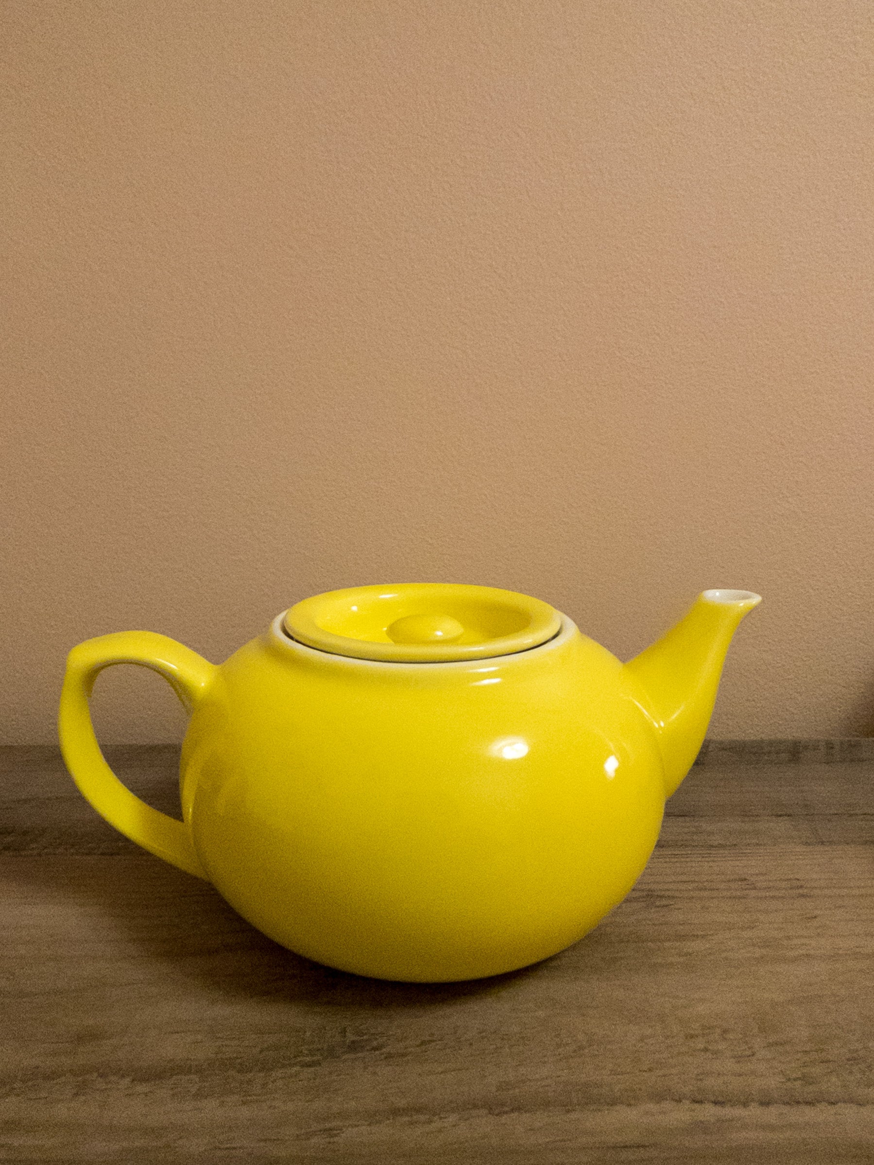 Yellow ceramic teapot.