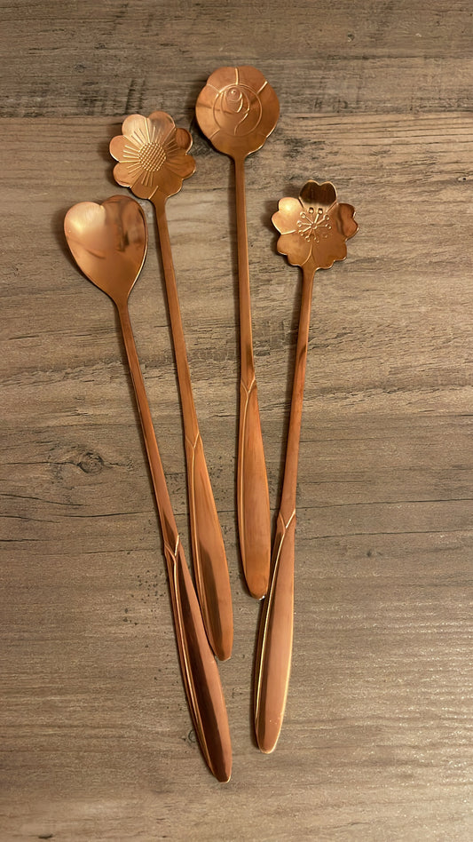 Rose gold teaspoons shaped: daisy, heart, rose, and cherry blossom.